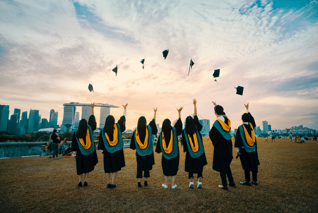 students throwing their graduation caps in the air