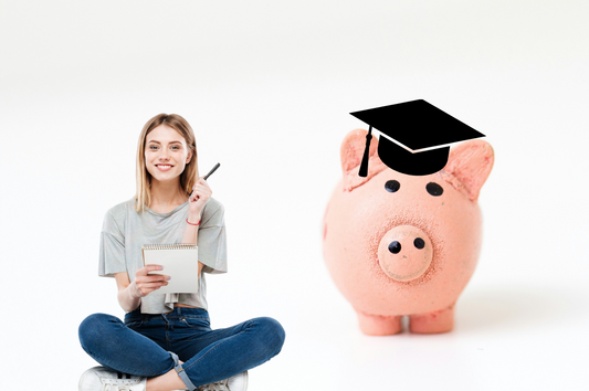 woman pointing with a pen to a piggy bank with a graduation cap on