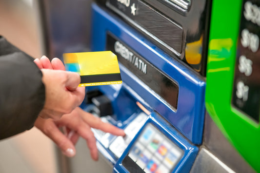 a person putting a card into an ATM 