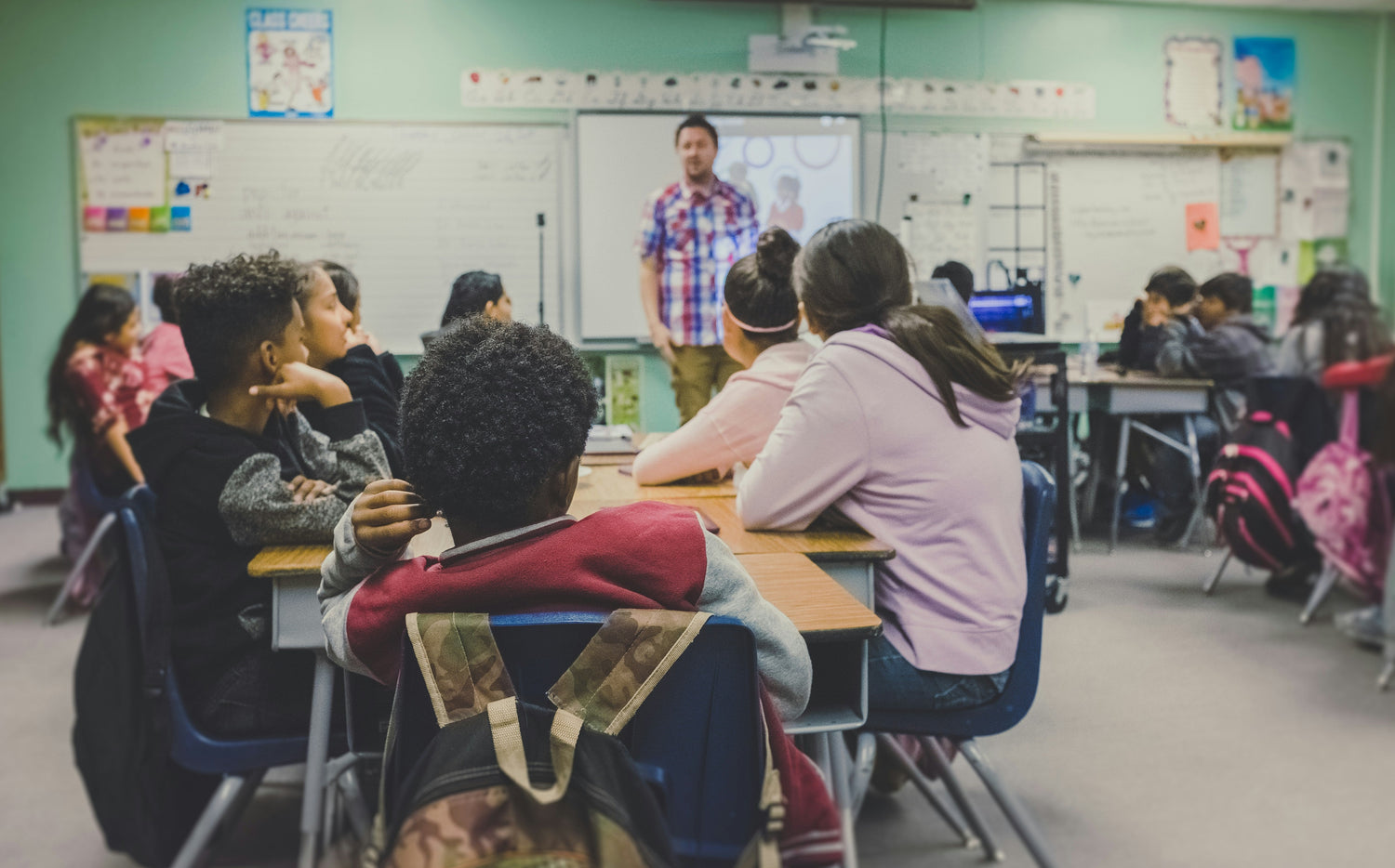 Students in a classroom learning with a teacher