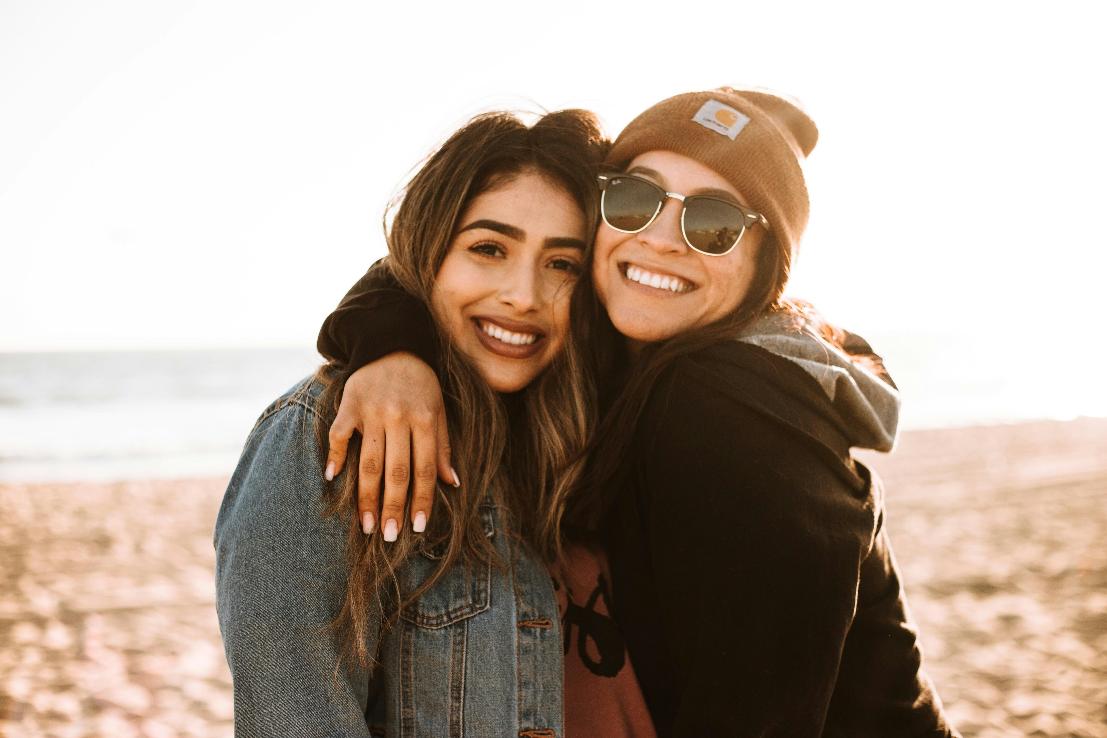 two female friends hugging and smiling