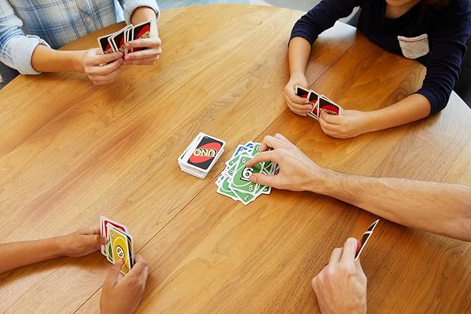 playing uno card game around a table